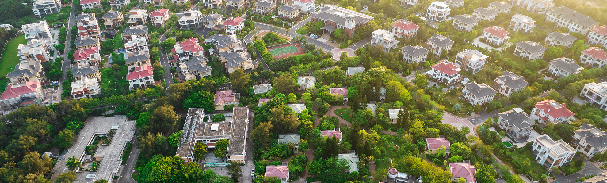 Aerial photo of luxury houses surrounded by trees and other greenery